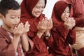 Muslim father,mother,daughter and son praying together Royalty Free Stock Photo