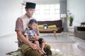 muslim father praying at home while babysit his son Royalty Free Stock Photo