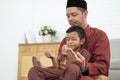 Muslim father and son praying together Royalty Free Stock Photo