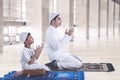 Muslim father and son praying together Royalty Free Stock Photo