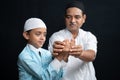 Muslim Father teaching his son how to do Salah or payer in a Islamic way. Royalty Free Stock Photo