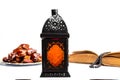 The Muslim feast of the holy month of Ramadan Kareem. Beautiful background with a shining lantern Fanus and dried dates on white w Royalty Free Stock Photo