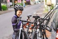 muslim female cyclist unloading her road bicycle on a rack in the back of her car Royalty Free Stock Photo