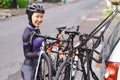 muslim female cyclist unloading her road bicycle on a rack in the back of her car Royalty Free Stock Photo