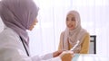 Muslim doctor giving pill to patient at hospital room Royalty Free Stock Photo