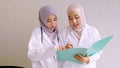 Muslim female doctor and medical assistants working together at hospital room