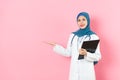 Muslim female doctor standing in pink background Royalty Free Stock Photo