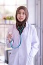 Close-up of a Muslim female doctor with stethoscope, and smiling confidently and looking at the camera Royalty Free Stock Photo