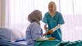 Muslim female doctor suggesting patient to drink water