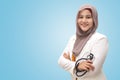 Muslim female doctor wearing hijab and suit, standing with crossed arm and holding stethoscope, succesful confident person Royalty Free Stock Photo