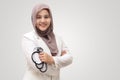 Muslim female doctor wearing hijab and suit, standing with crossed arm and holding stethoscope, succesful confident person Royalty Free Stock Photo