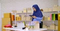 Muslim female merchandiser doing online marketing at the office