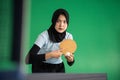 Muslim female table tennis player holding ball preparing to serve Royalty Free Stock Photo