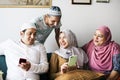 Muslim friends using social media on phones