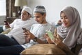 Muslim friends using social media on phones