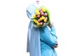 Muslim girl holding a bouquet of tulips in her hands, stands sideways. Isolate. Royalty Free Stock Photo