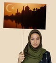 Muslim girl holding a sign