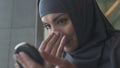 Muslim girl powdering face, religious ban on cosmetics for Islamic women closeup