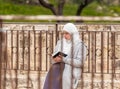 Muslim girl sits and reads the Quran on the Temple Mount near to the Golden Gate - Gate of Mercy in the Old Town of Jerusalem in
