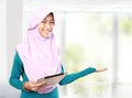 Muslim girl with tablet computer presenting
