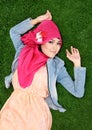 Muslim girl wearing hijab lying on grass Royalty Free Stock Photo