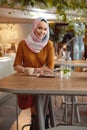 Muslim Girl. Young Woman In Hijab Portrait. Beautiful Female Sitting In Cafe And Drinking Coffee. Royalty Free Stock Photo