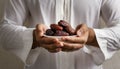 Muslim hands share a fistful of dates. ramadan kareem concept