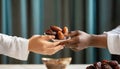 Muslim hands share a fistful of dates. ramadan kareem concept