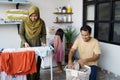 Happy muslim family doing laundry at home Royalty Free Stock Photo