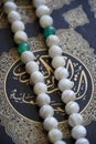 Holy book of Quran with rosary