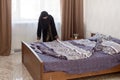 Muslim immigrant woman making bed