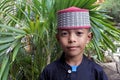 Muslim Indonesian boy dressed in traditional clouting looking at camera Royalty Free Stock Photo