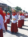 Muslim Indonesian students walking and marching on the street with uniforms in celebrating the country's Independence Day.