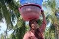 Muslim Indonesian woman carry a basket on her head in Gili Air Island Indonesia