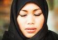 Muslim indonesian woman with closed eyes