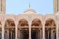 Muslim Islamic Arabian mosque made of white brick for praying architectural construction with arches, domes and carved triangular