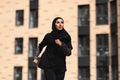 Muslim Jogger. Young Islamic Female In Modest Sportswear Running Outdoors