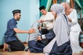 family forgiving each other and shake their hand on idul fitri