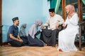 family forgiving each other and shake their hand on idul fitri