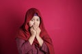 Muslim lady close her mouth, worried nervous gesture