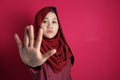 Muslim Lady in Red Shows Stop Gesture Royalty Free Stock Photo