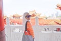 Muslim lady wearing hijab and orang top at a chinese temple Royalty Free Stock Photo