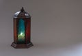 Muslim lamp with candle on gray background.