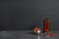 Muslim lantern Fanous, dried dates and prayer beads on table against dark background