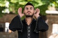 Muslim Man In Dishdasha Praying At Mosque