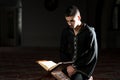 Muslim Man In Dishdasha Is Reading The Quran Royalty Free Stock Photo