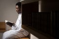 Muslim Man In Dishdasha Is Reading The Quran Royalty Free Stock Photo