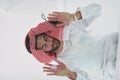 Muslim man doing sujud or sajdah on the glass floor Royalty Free Stock Photo