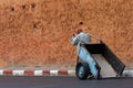 A Muslim man hauling the blue cart