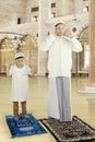 Muslim man and his son praying together Royalty Free Stock Photo